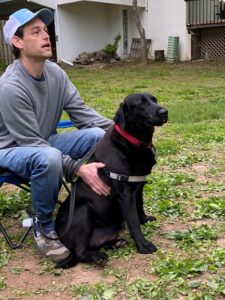 black Labrador Retriever and a man